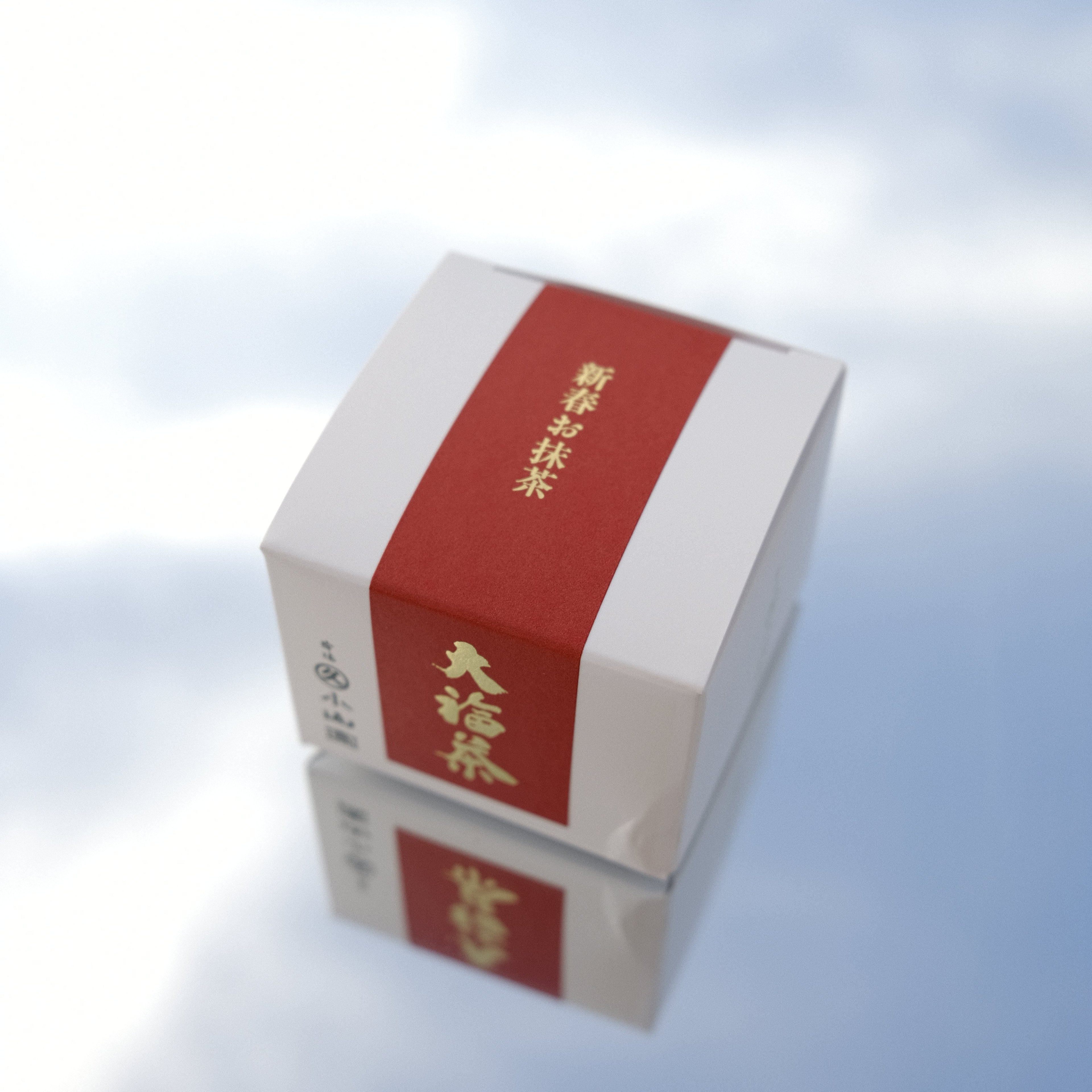 Red and white boxes with gold text against a blue sky