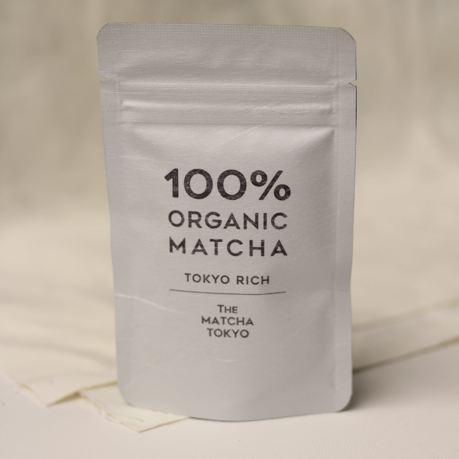 A packaged product labeled '100% Organic Matcha' with 'Tokyo Rich' and 'The Matcha Tokyo' written on it.